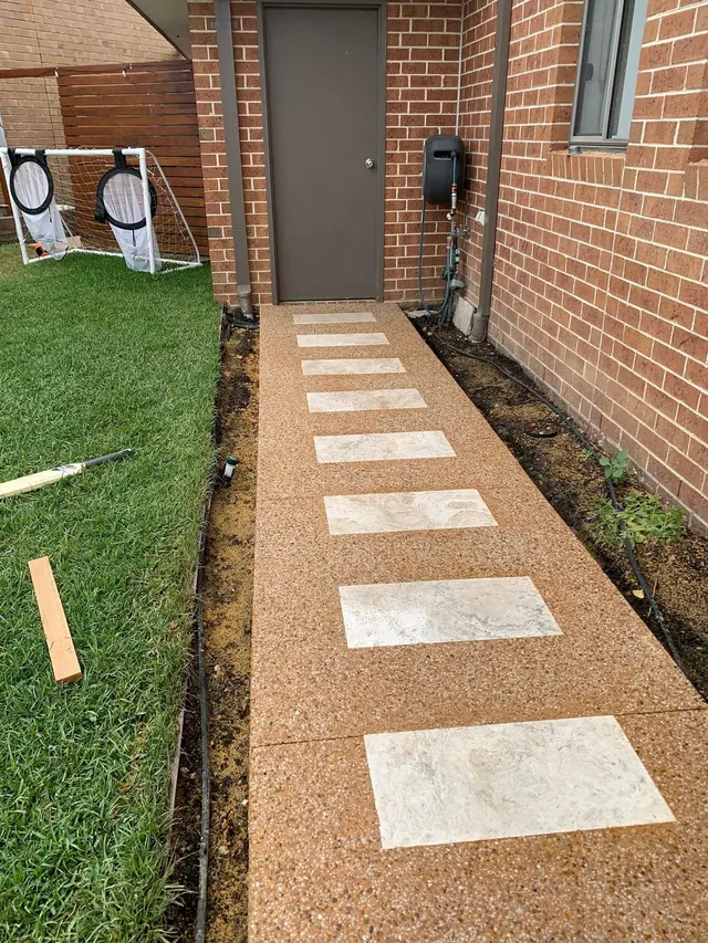 Decorative feature path with stepping stones on lawn